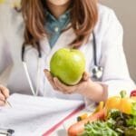 Infographic listing the top 10 foods that promote eye health, featuring colorful images of each food item.