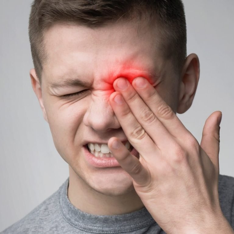 A man with conjunctivitis, featuring a red eye and a red spot on his face.